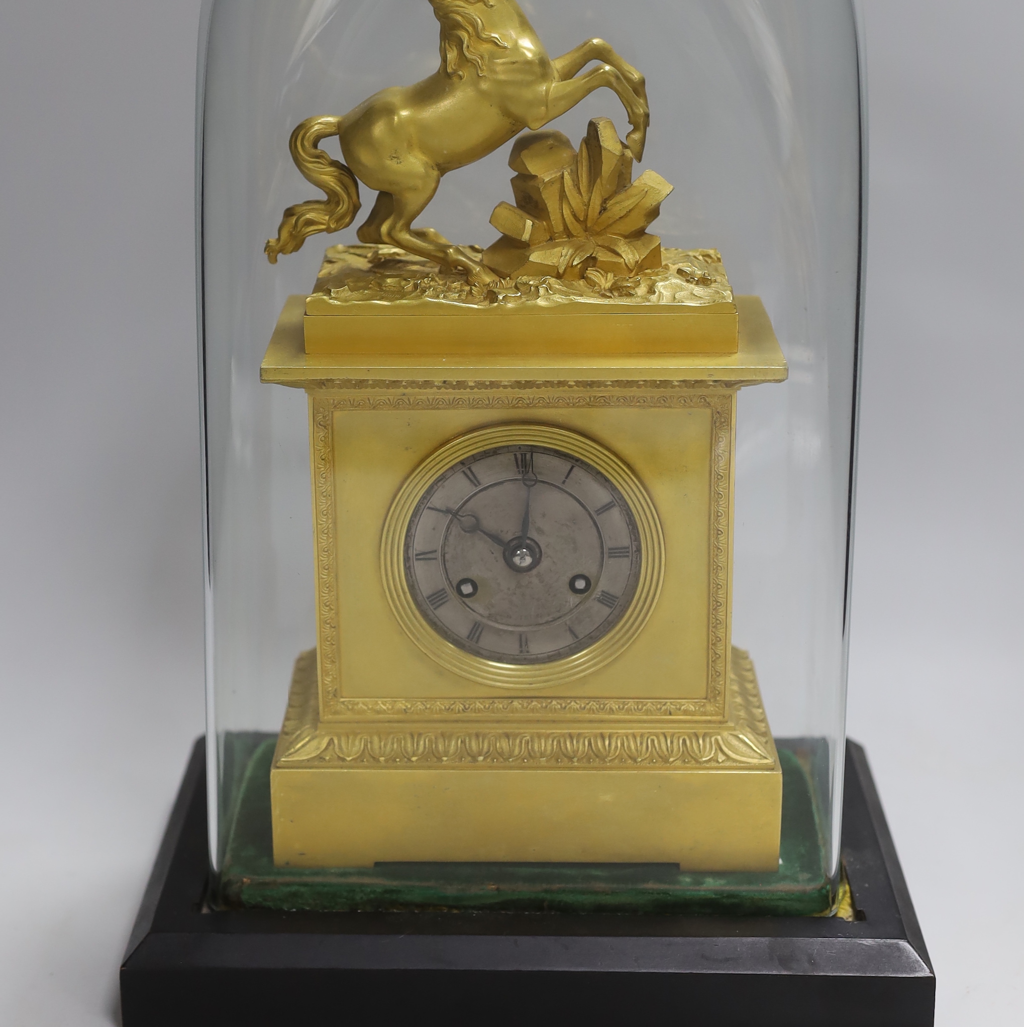 A French mid 19th century gilt mantel clock under dome, striking on a bell, 38 cm high